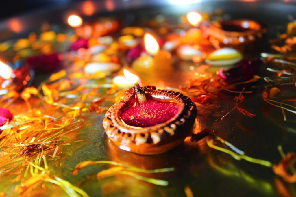 Photo by Ravi Roshan: https://www.pexels.com/photo/close-up-shot-of-lighted-candles-during-diwali-5872616/